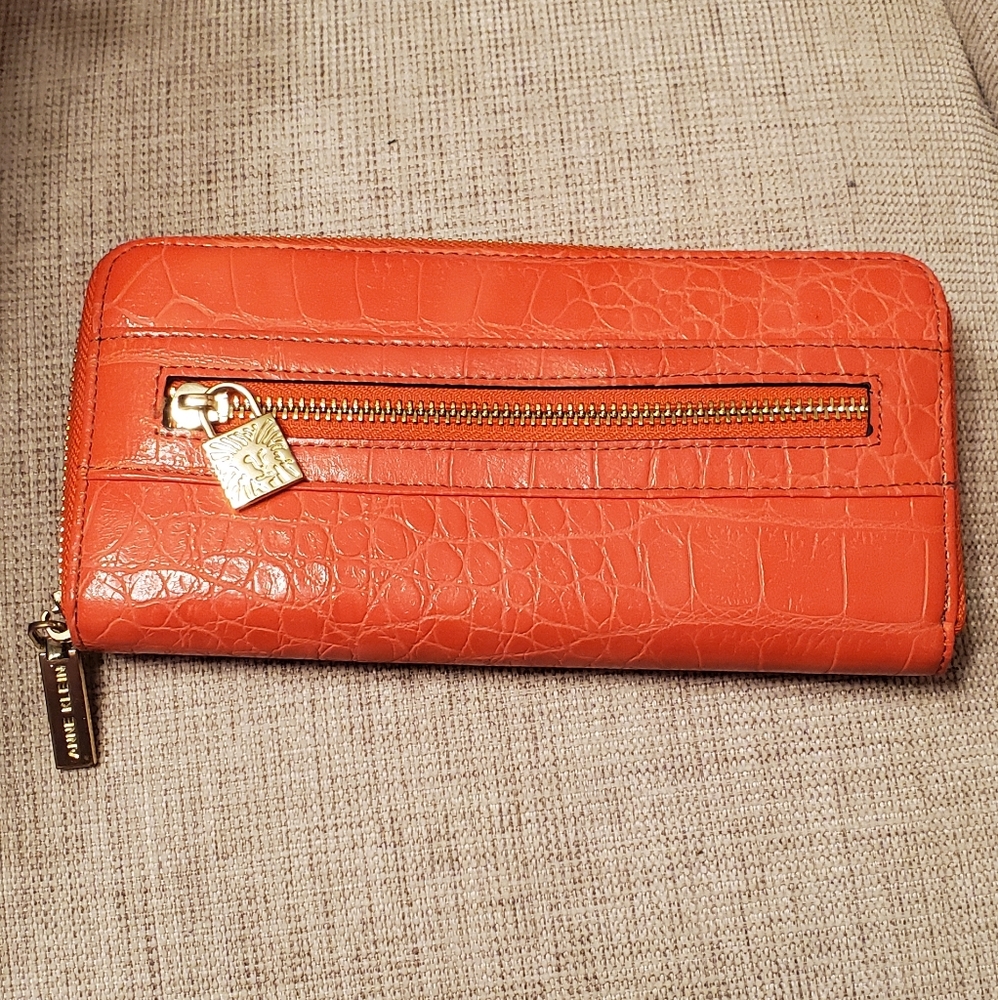 Anne Klein zippered wallet, orange with gold zippers and embellishment lock.